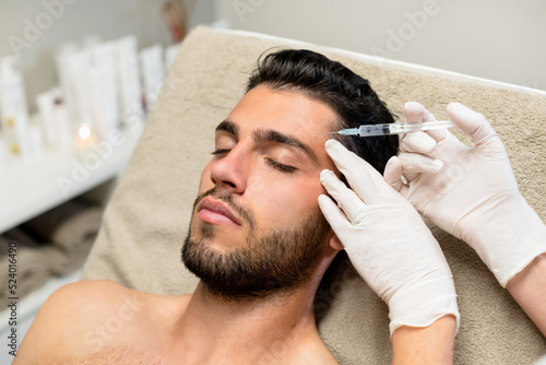 Young man receiving botox injection photo