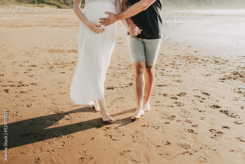 wedding couple sitting embraced on the beach