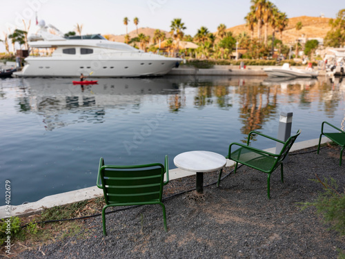 empty marble table in front of marina background, close up © bahadirbermekphoto