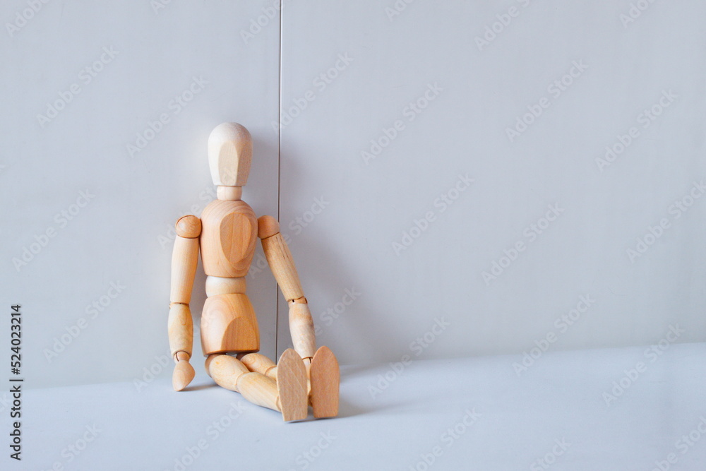 Concept of loneliness and abandonment with a wooden doll as a model Concept of loneliness and abandonment with a wooden doll as a model