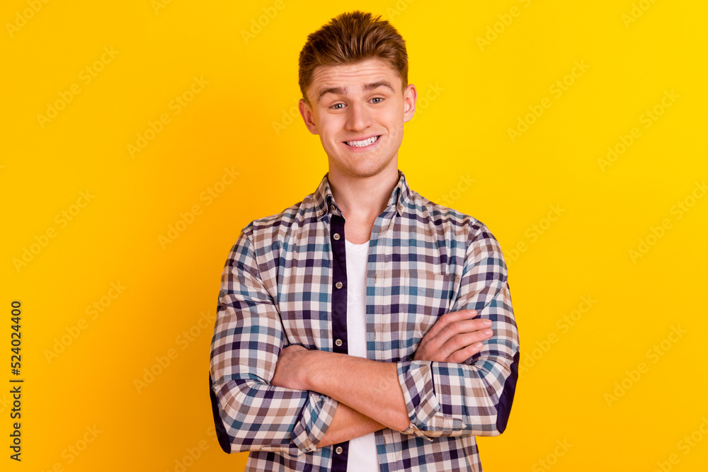 Photo of young cheerful man folded hands clever agent manager representative isolated over yellow color background Photo of young cheerful man folded hands clever agent manager representative isolated over yellow color background