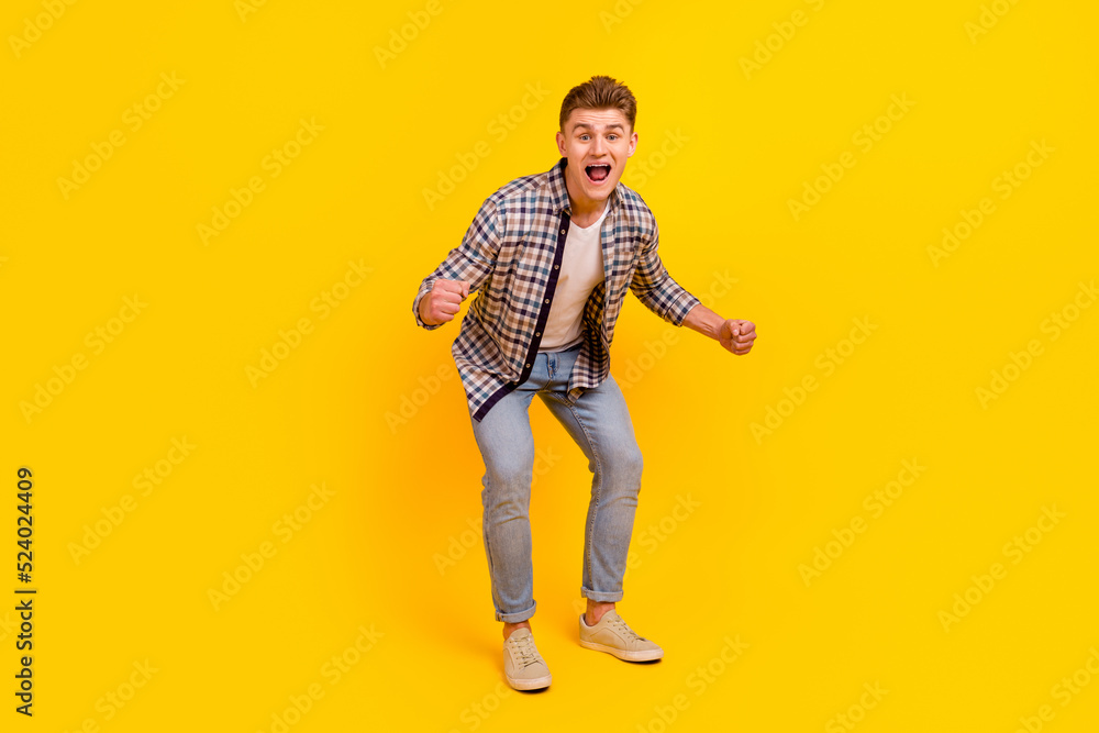 Naklejka premium Full length photo of young excited man rejoice victory fists hands scream isolated over yellow color background