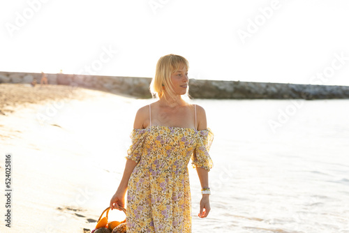 Beautiful woman walking at the beach. Happy woman enjoy at sunny day photo