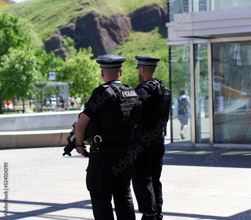 Police officer on duty on a city centre street during special event. 