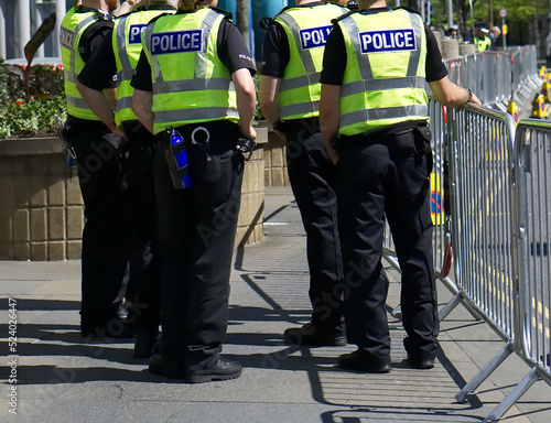 Police officer on duty on a city centre street during special event. 
