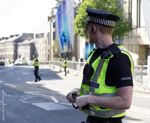 Police officer on duty on a city centre street during special event. 