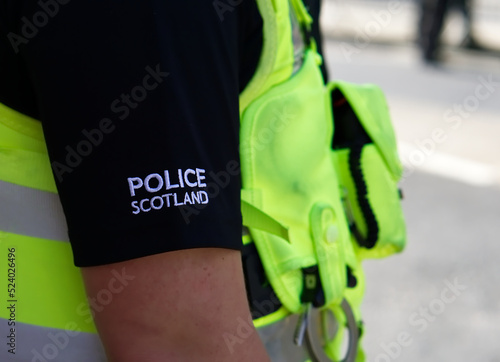 Police officer on duty on a city centre street during special event. 