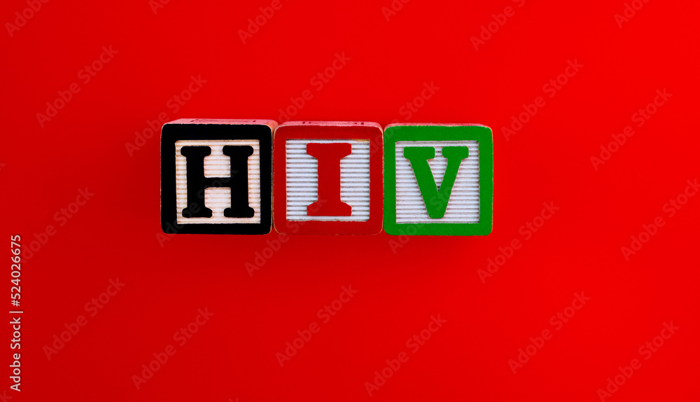 Wood blocks spelling HIV on red background Wood blocks spelling HIV on red background