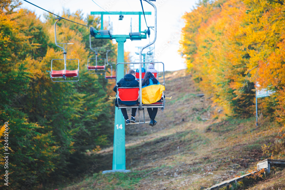 people on chairlift autumn season people on chairlift autumn season