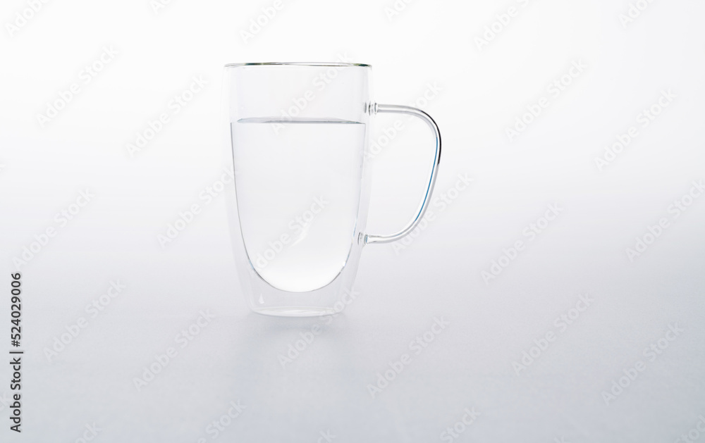A glass of water on blue background A glass of water on blue background