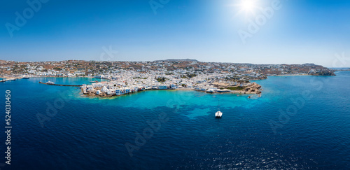 Wide, aerial panorama of the town amd harbour of Mykonos island, Cyclades, Greece, during summer time