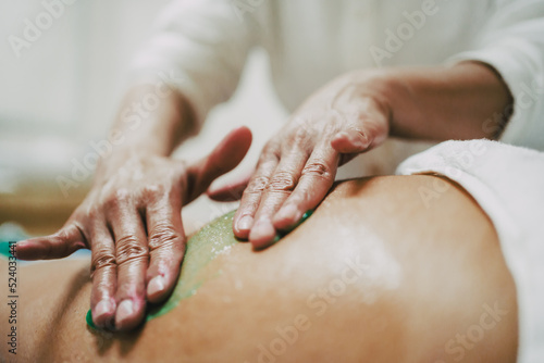professional giving a massage to a woman. relax and beauty concept