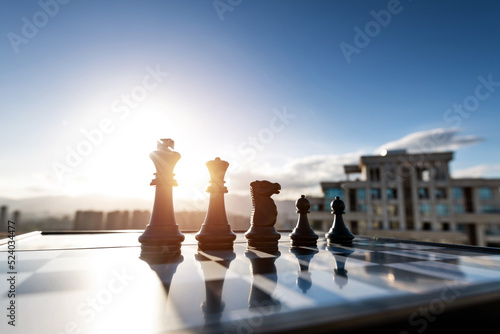 Chess pieces on city background