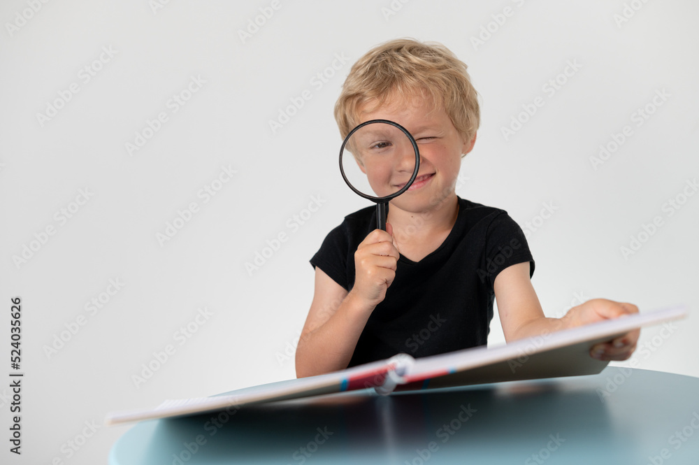 Boy with a pencil sitting at a table, school education Boy with a pencil sitting at a table, school education