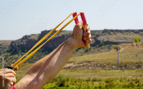 Man using spear thrower throwing rock nature amusement