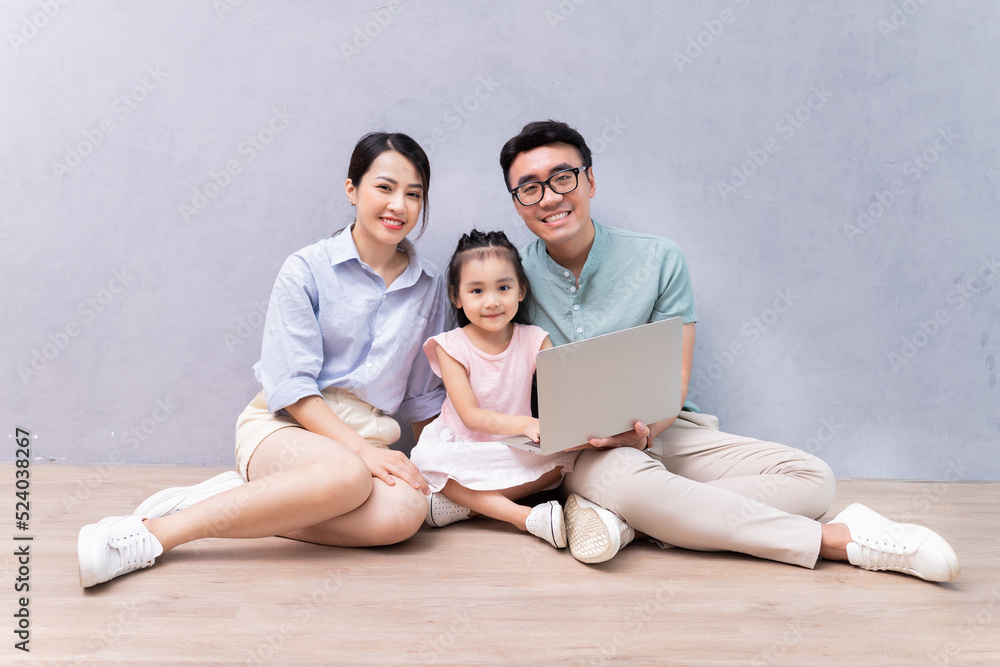 Young Asian family sitting on the floor