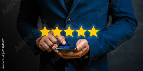 Tableau sur toile Businessman customer giving five star rating on cellphone