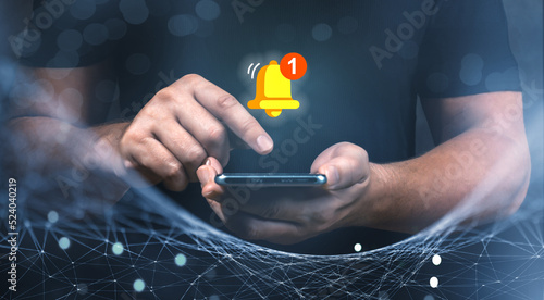 Man holding cellphone and touching with virtual bell for E-mail with notification alert, Contact us or Customer support hotline people, connection and communication photo
