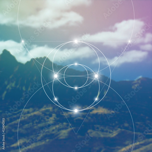 Sacred geometry spiritual new age futuristic illustration with interlocking circles, triangles and glowing particles in front of blurry natural photographic background