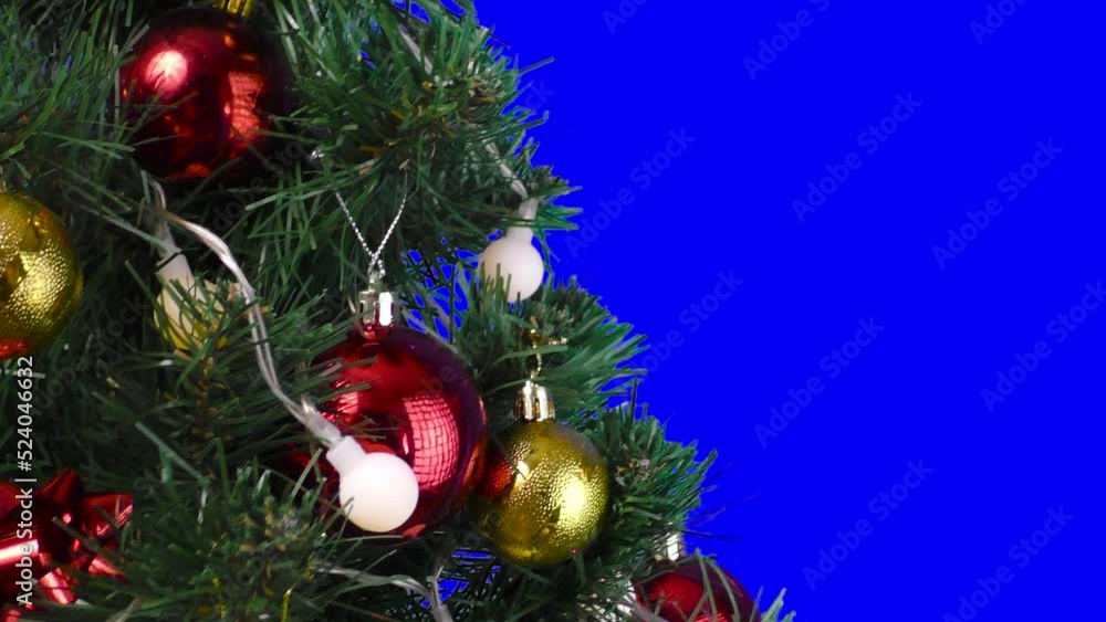 On a blue background, a large Christmas tree decorated with flashing lights and balls On a blue background, a large Christmas tree decorated with flashing lights and balls
