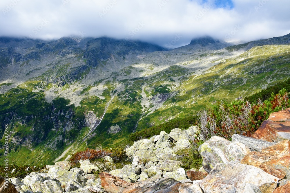 Fototapeta premium Mountain slopes bellow Hochalmspitze in High Tauern mountains with the peak covered in clouds in Carinthia, Austria