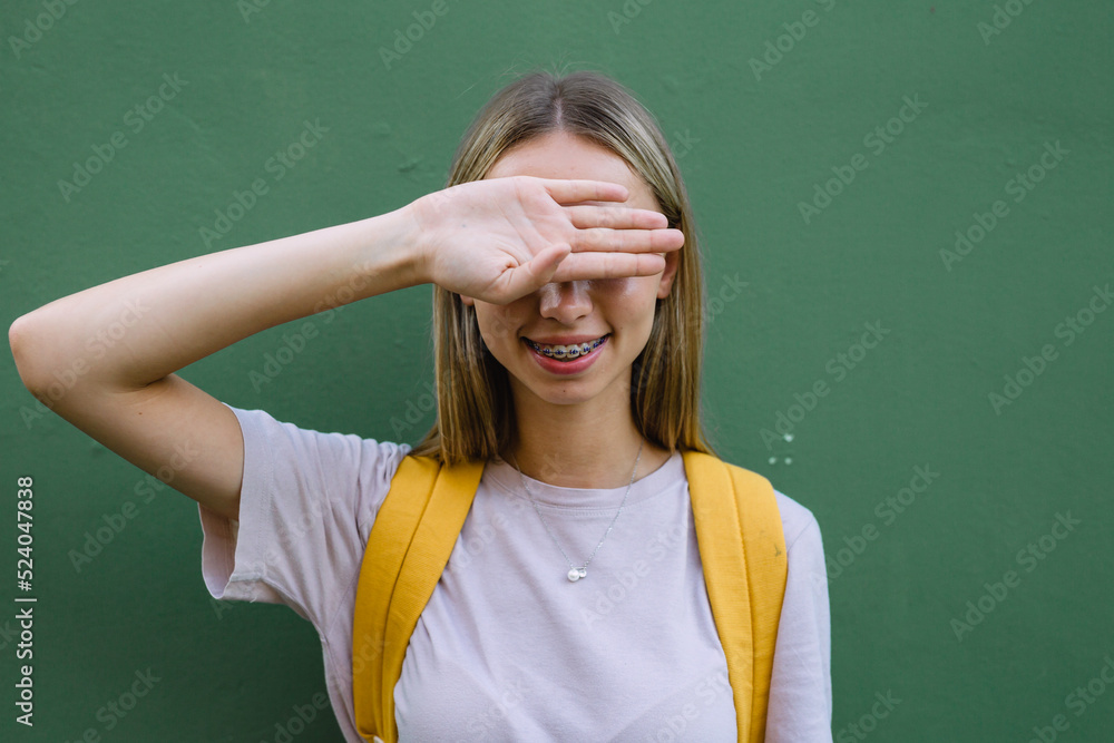 the teenager girl covered her eyes with her hand