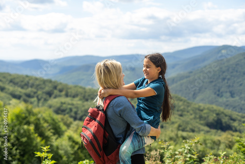 Mother and Daughter enjoying the view after a mountain hike © Angelov