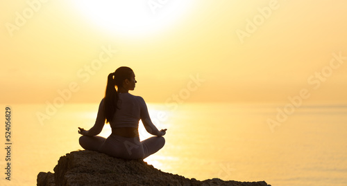 Fototapeta Naklejka Na Ścianę i Meble -  Serenity and yoga practicing at sunset, meditation. silhouette on sea background with sunrise