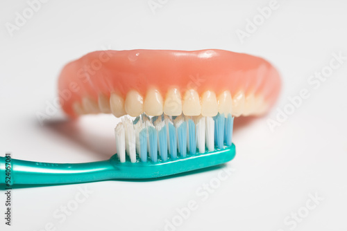 Denture and toothbrush - dental cleaning instruction