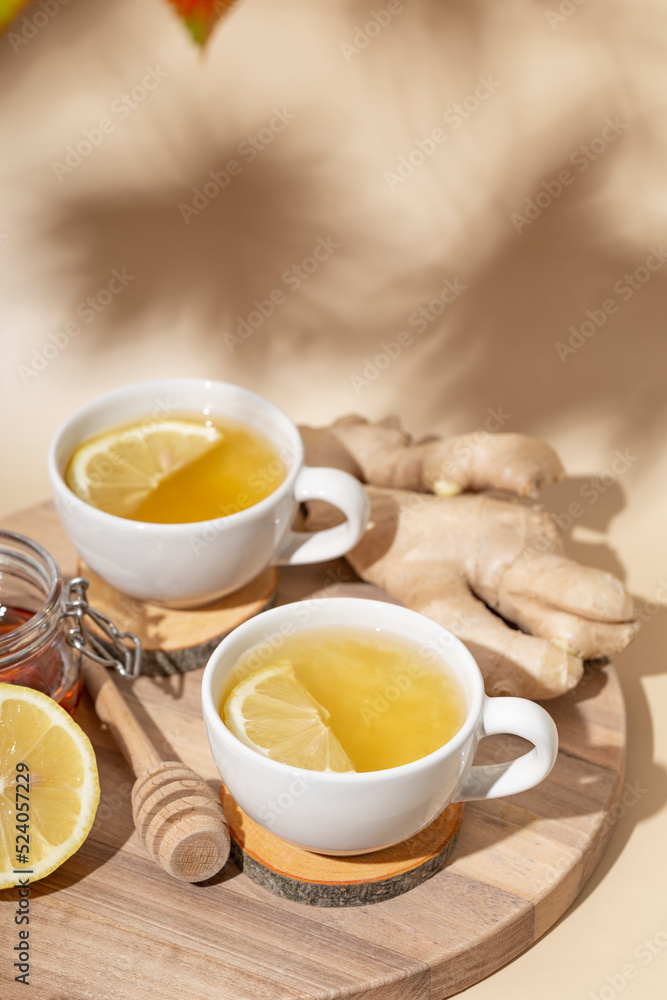 Cup of hot tea with ginger, honey and lemon on the beige background vertical photo Cup of hot tea with ginger, honey and lemon on the beige background vertical photo