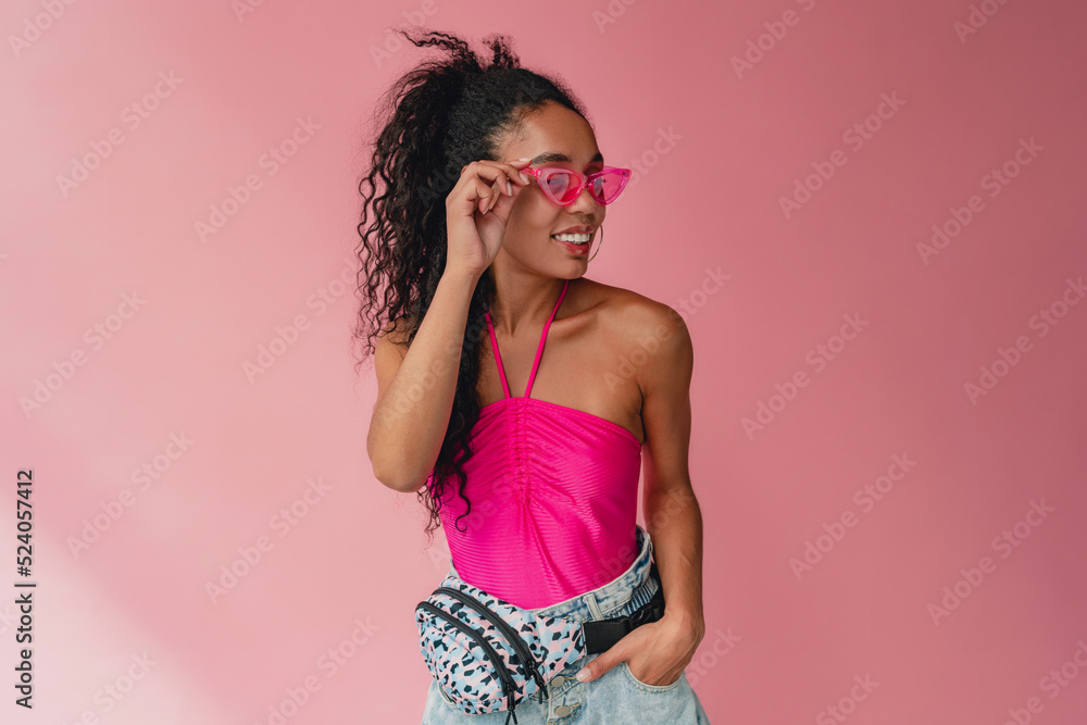 attractive black african american woman in stylish outfit on pink background attractive black african american woman in stylish outfit on pink background