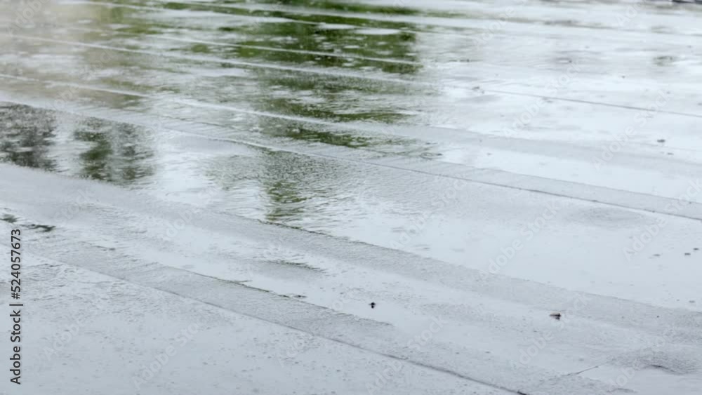 Raindrops knock on the roof, heavy rain, downpour. The flat roof of the building is covered with a waterproof material that protects from rain. Ruberoid, rolled roofing and waterproofing material. Raindrops knock on the roof, heavy rain, downpour. The flat roof of the building is covered with a waterproof material that protects from rain. Ruberoid, rolled roofing and waterproofing material.