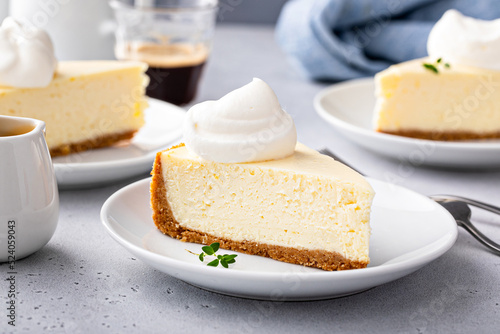 Classic New York cheesecake with a dollop of whipped cream photo