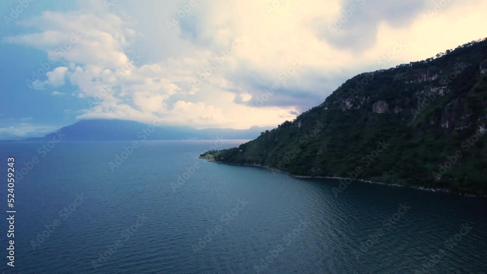 Aerial drone shot of Central American volcano Volcan San Pedro in Lake Atitlan, Guatemala on a cloudy day. Aerial drone shot of Central American volcano Volcan San Pedro in Lake Atitlan, Guatemala on a cloudy day.