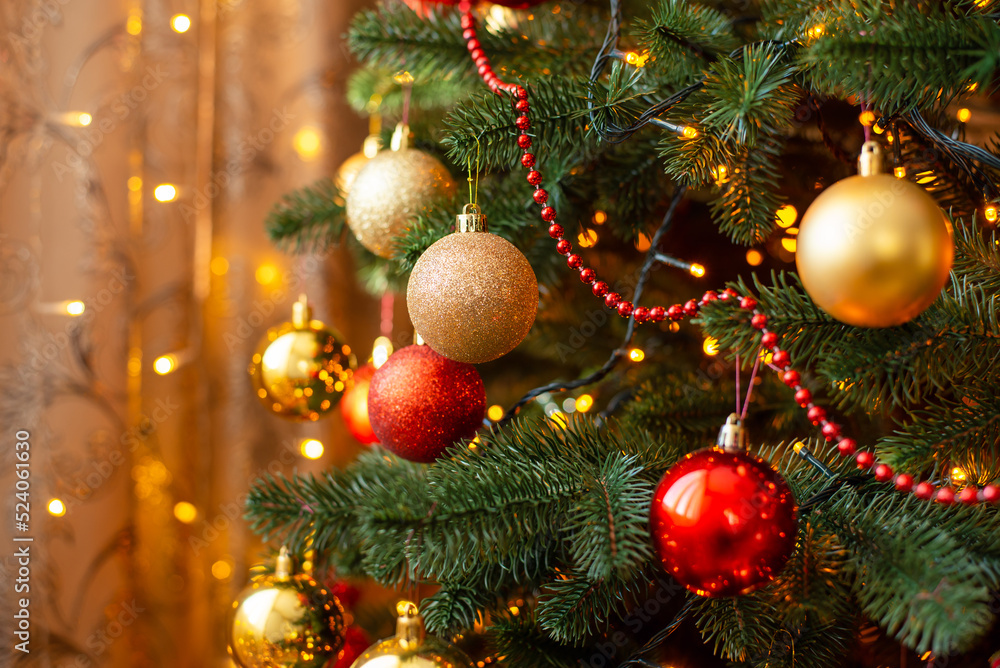 Close up shot of Christmas tree with bright lights on the background. Beautiful interior, warm atmosphere before holidays