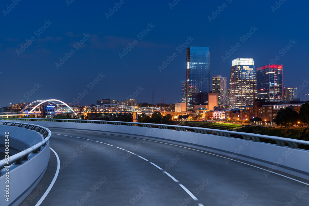 Empty urban asphalt road exterior with city buildings background. New modern highway concrete construction. Concept of way to success. Transportation logistic industry fast delivery. Nashville. USA.