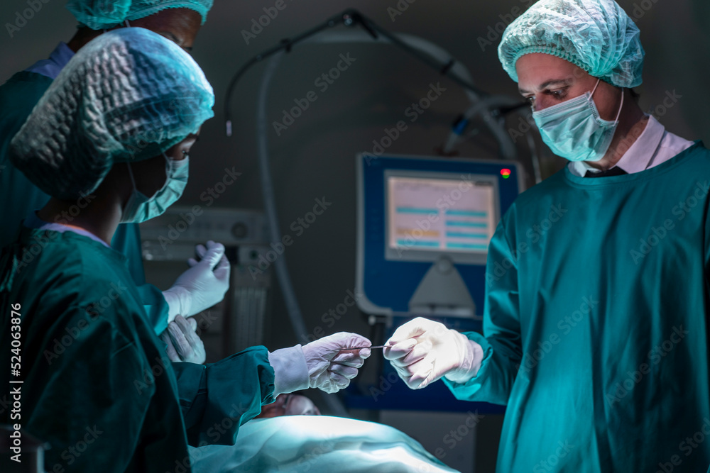 doctor wearing a sterile uniform, wearing a surgical gown, wearing a magnifying glass, works on a patient in a hospital operating room. doctor wearing a sterile uniform, wearing a surgical gown, wearing a magnifying glass, works on a patient in a hospital operating room.