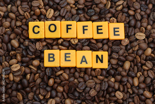 Coffee bean word on roasted coffee beans background. Concept for cafe  coffee shop and drinking coffee beverage.