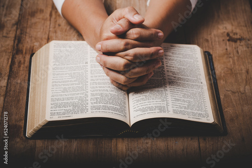 Obraz na płótnie Close up of christian woman hand on holy bible are pray and worship for thank go