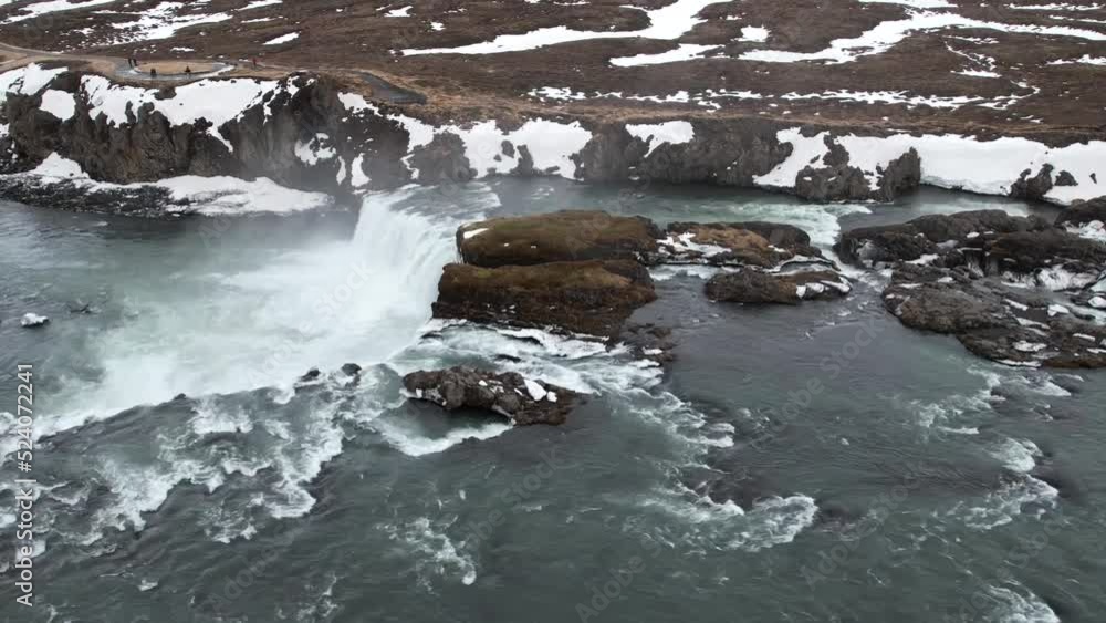 Scenic waterfall streaming from rocky cliff on winter day Scenic waterfall streaming from rocky cliff on winter day