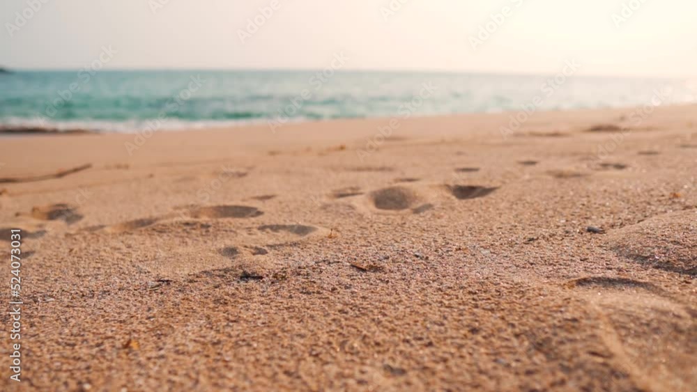 Closeup shot of sand of the beach with sea in the background at Goa in India. Beach background. Selective focus on the sand with out of focus sea in background. Beach background with copy space. Closeup shot of sand of the beach with sea in the background at Goa in India. Beach background. Selective focus on the sand with out of focus sea in background. Beach background with copy space.