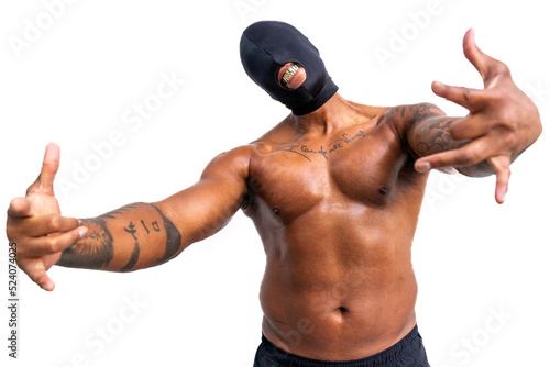 Shirtless tattooed African American man with eyeless black mask, gold fangs, and arms outstreached photo