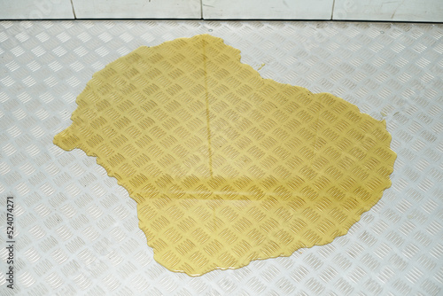 Large yellow puddle of liquid or urine on the floor in the elevator