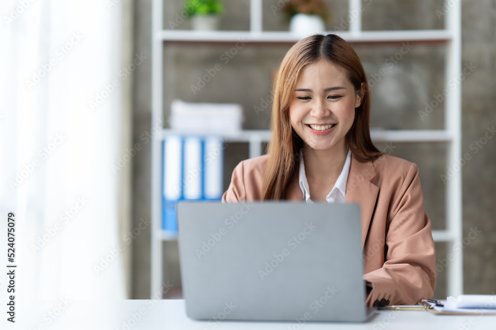 Asian woman working with laptop in her office. business financial concept. Asian woman working with laptop in her office. business financial concept.