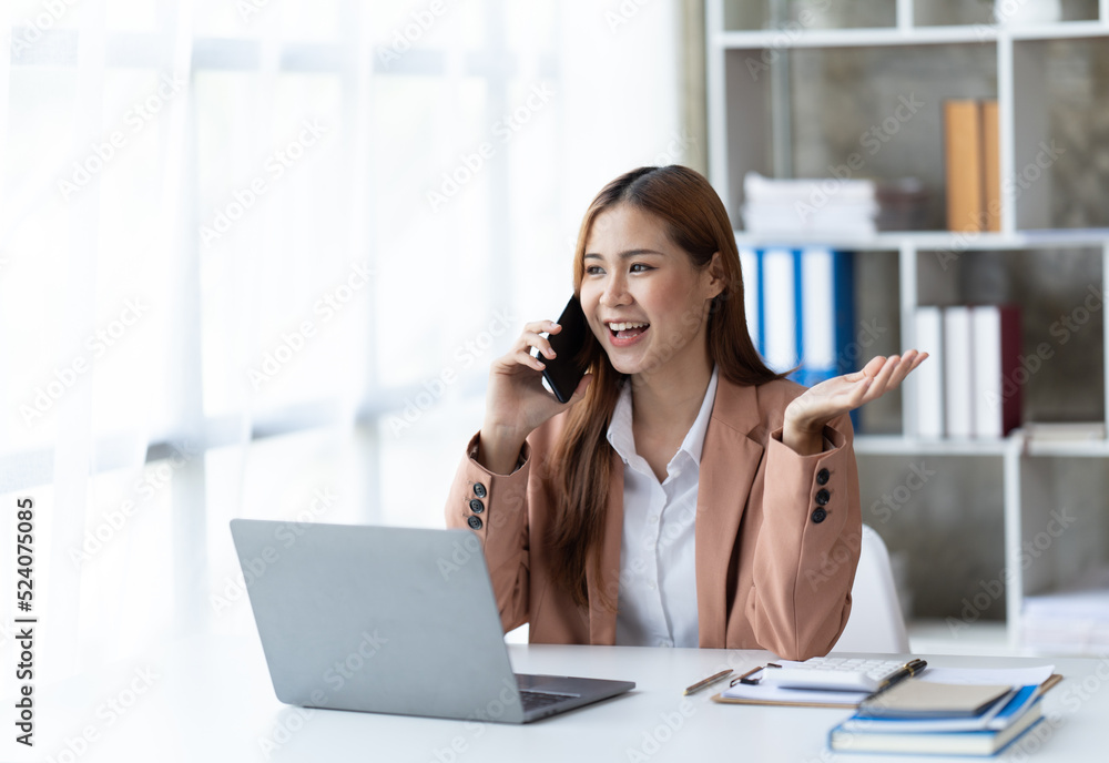 Asian businesswoman in formal suit in office happy and cheerful during using smartphone and working. Asian businesswoman in formal suit in office happy and cheerful during using smartphone and working.