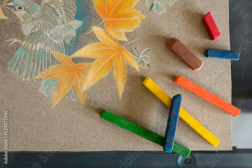 Bunch of pastels on drawing