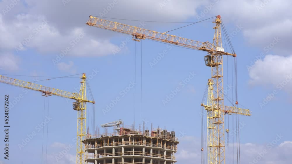 Time lapse of a large construction site with many cranes working over building Time lapse of a large construction site with many cranes working over building