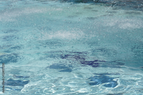 Selective focus of clear water reflection in the swimming pool