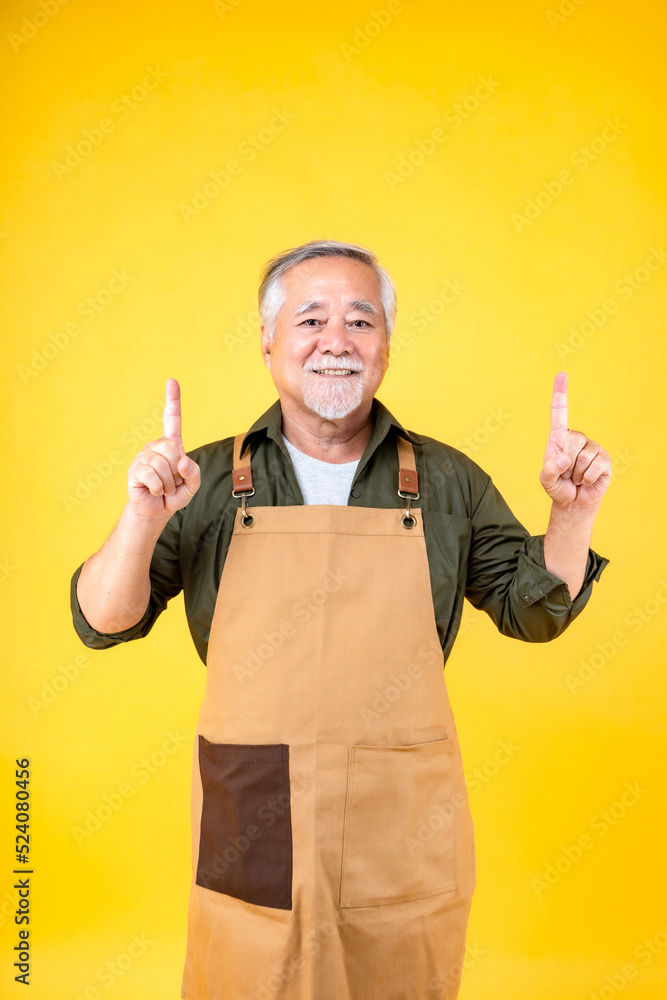 Portrait charming retired asian elder man has a white mustache and beard wearing apron point hands to copy space. Portrait charming retired asian elder man has a white mustache and beard wearing apron point hands to copy space.