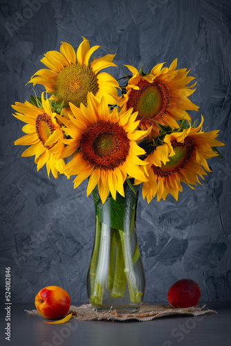 Still life with bouquet of sunflowers on a grey table